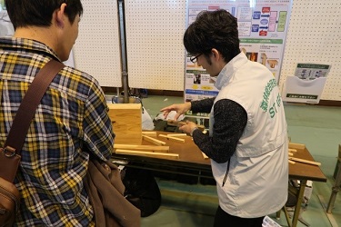 CLT（直交集成板）の技術開発の説明を聞いている様子