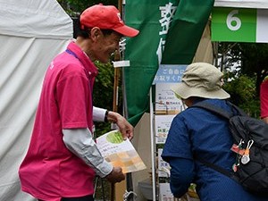 来場者に森林総合研究所が発行している刊行物を紹介している研究者