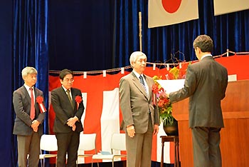 写真3：感謝状及び副賞の授与を受ける沢田理事長と鈴木理事、田中理事